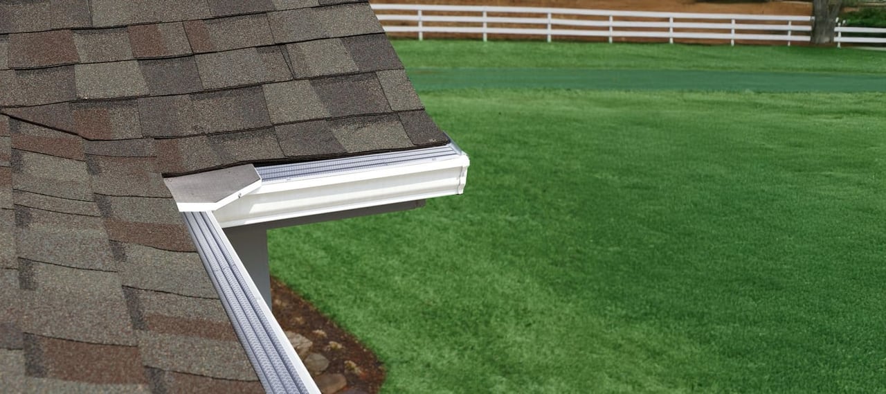 Evelyn's Leaf Solution corner miter installed on a rural Virginia home with a white fence and green pasture